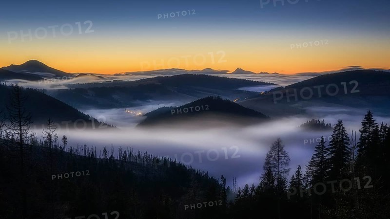 Fog over the Liptov village of Velke Borove before sunrise by Liptovska Mara in Slovakia