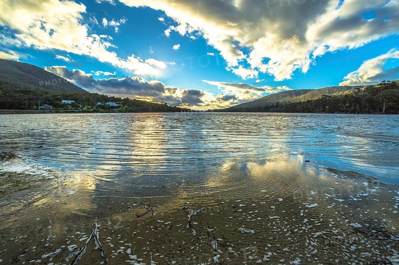Wild landscapes with clouds reflected in the water, in Tasman Peninsula in South Eastern Tasmania, Australia