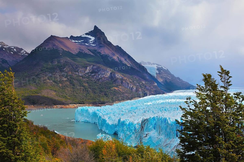 Los Glaciares National Park in Patagonia. Huge Perito Moreno glacier in the Lake Argentino, surrounded by mountains. Sunny summer day