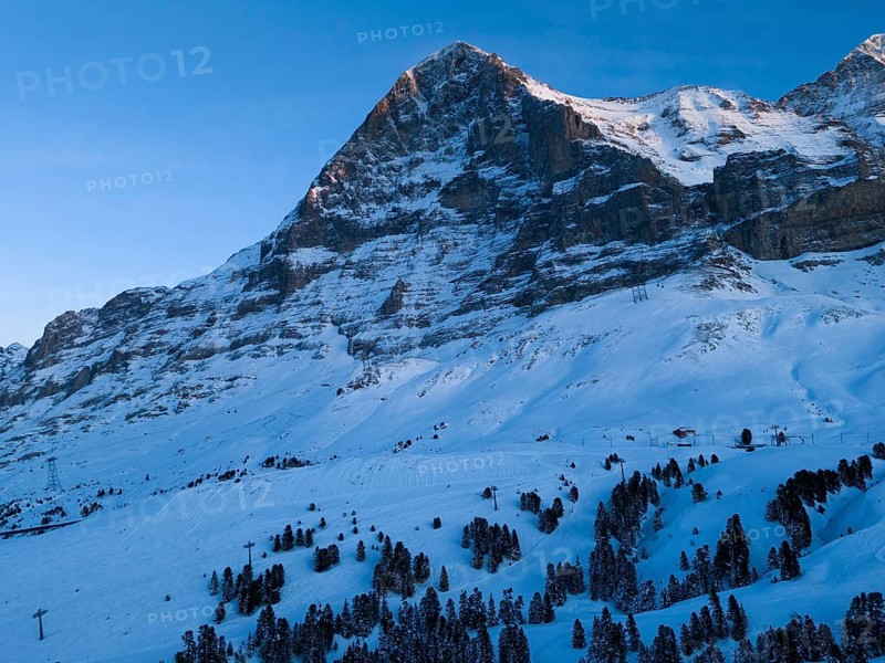Eiger North Face Mountain at Sunset in Winter. Evening Twilight, Blue Hour. Swiss Alps. Switzerland. Aerial View