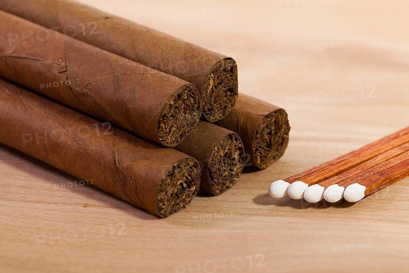 Different cigars on wooden table