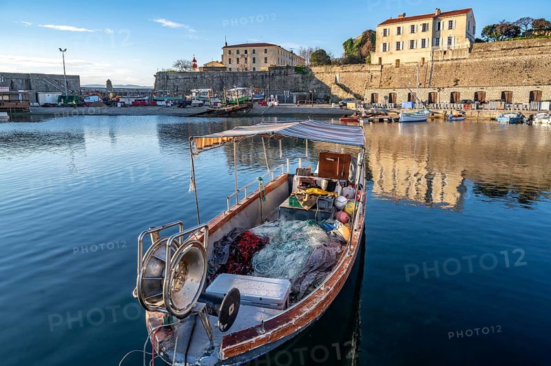 Small traditional fishing boat in Port Tino Rossi, the fishing and pleasure boat harbour near the citadel of Ajaccio, Corsica, France