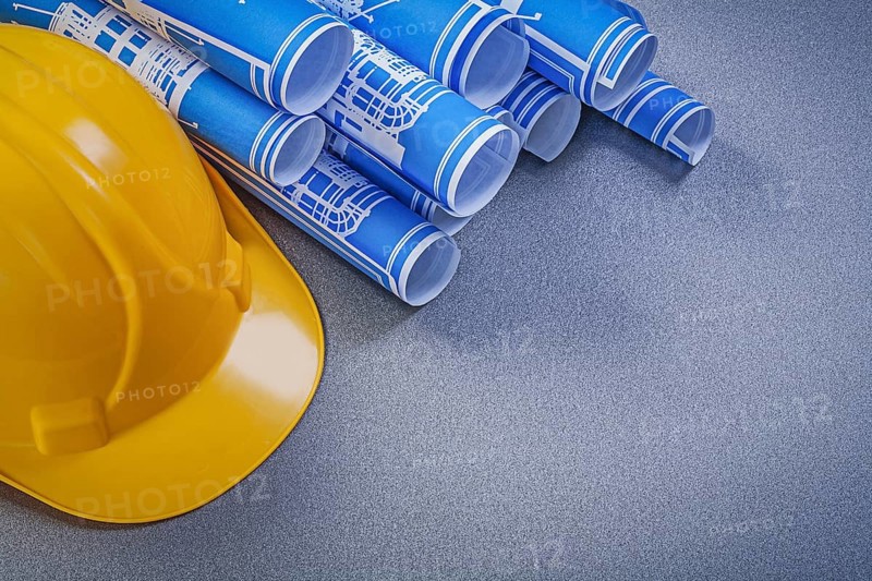 Hard hat blue construction drawings on grey background
