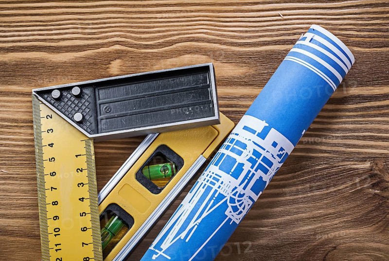 Blue construction drawing level square ruler on wooden board