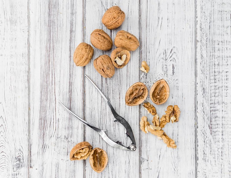 Walnuts on an old wooden table as detailed close-up shot (selective focus)