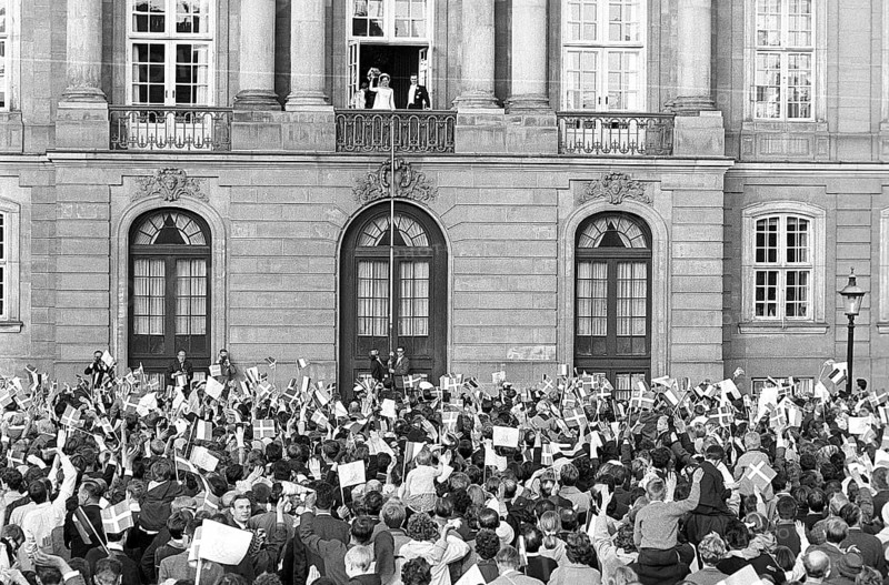 Margrethe II of Denmark. Pictured with Henri de Laborde de Monpezat at Fredensborg palace in Copenhagen after their wedding on June 10 1967. Greeted by a crowd of people waving flags