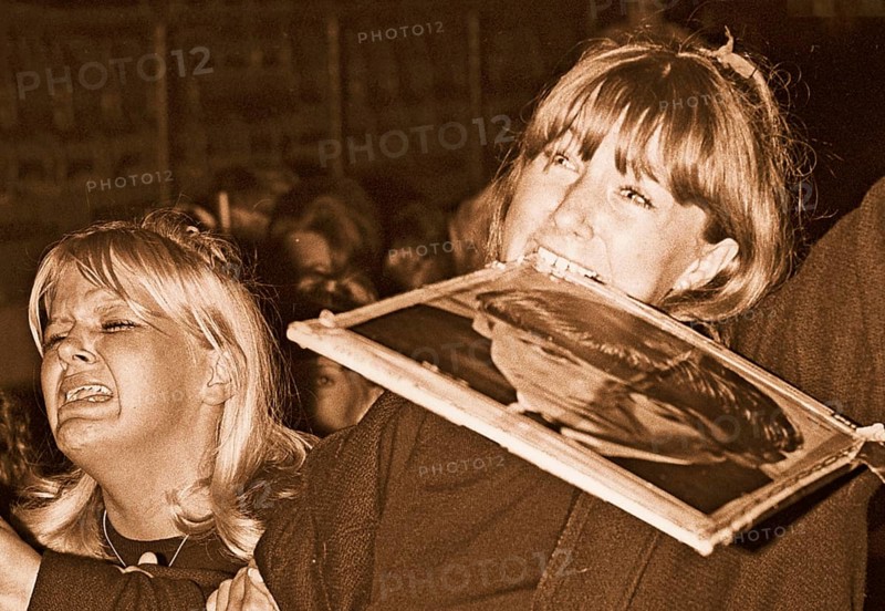 Beatles in the 1960s. Fans at a Beatles concert in Stockholm 1964 July 28 on Johanneshov stadion. Pictured a scene from the concert and the audience who is in extacy. The girl on the right is holding a portrait of Ringo Starr in her mouth