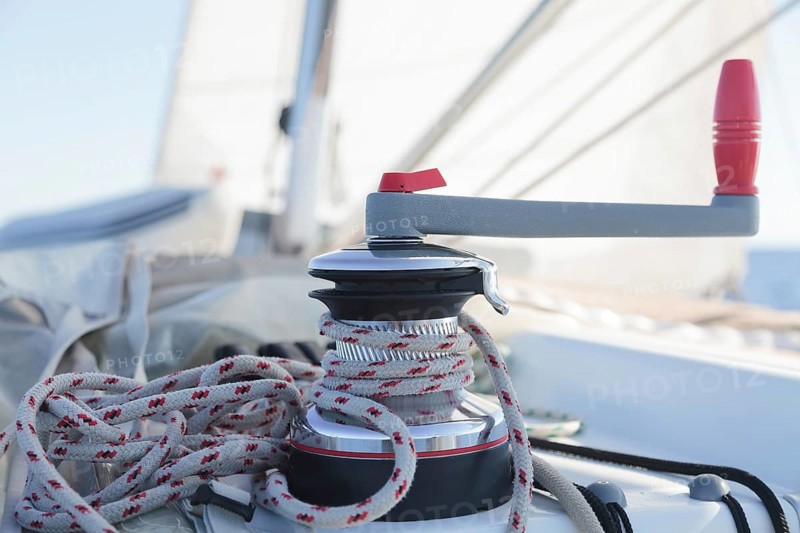 Winch with rope on sailing boat in the sea