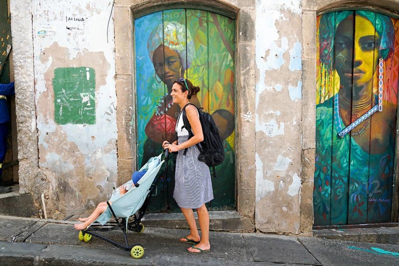 Tourist walking in the colorful historic district of Pelourinho, Bahia, Brazil. Historic neighborhood famous attraction for tourist sightseeing. February 11th, 2020