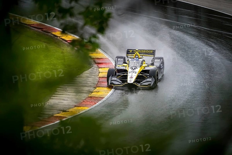 COLTON HERTA (26) of Valencia, California comes through turn 12 (Canada Corner) during a wet practice session for the XPEL Grand Prix at Road America in Elkhart Lake, WI