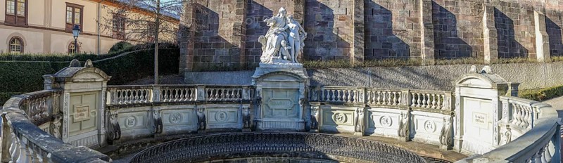 Panoramic photo of the source of the Danube and the Mother Baar figure group in front of the Catholic Church of St. John, Donaueschingen, Southern Black Forest, Black Forest, Baden-Württemberg, Germany