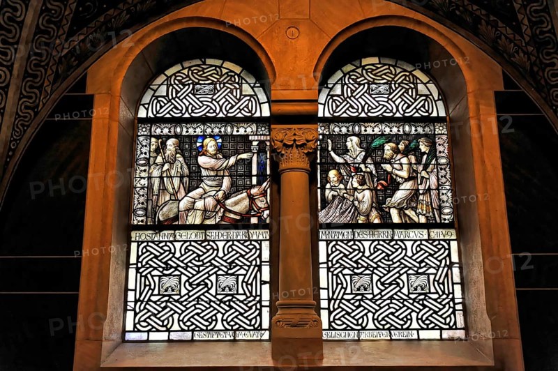 Stained glass window with sacred scenes and filigree stained glass in a church wall, Bad Homburg v. d. Höhe, Hesse, Germany