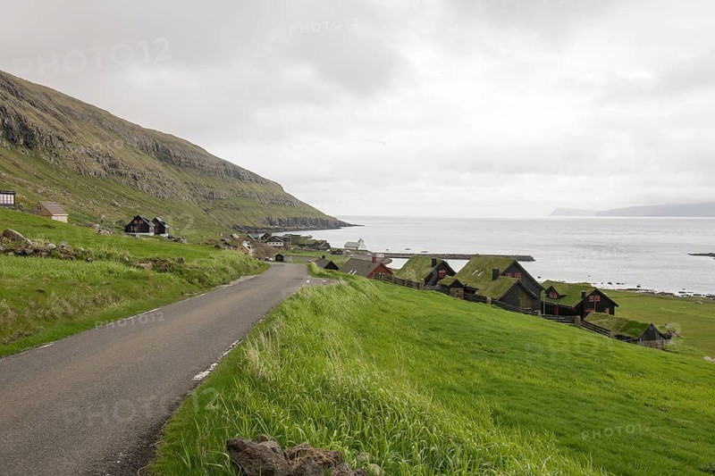 Kirkjubøur on the Faroe Islands with typical houses, church and road, Kirkjubøur, Faroe Islands, Denmark