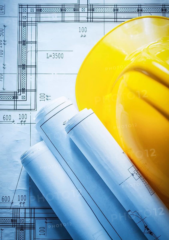 Building helmet rolled construction drawings on blueprint