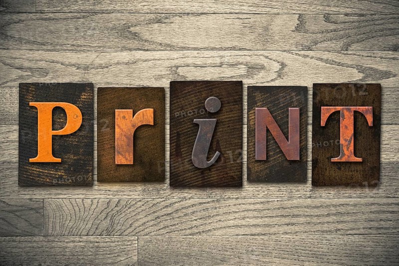The word PRINT written in wooden letterpress type