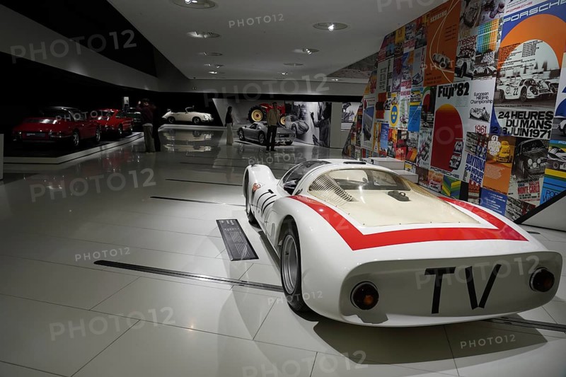 Porsche 906 Carerra 6, white racing car with red stripes, embedded in a colourful historical exhibition, New Porsche Museum 2009, Stuttgart, Baden-Württemberg, Germany