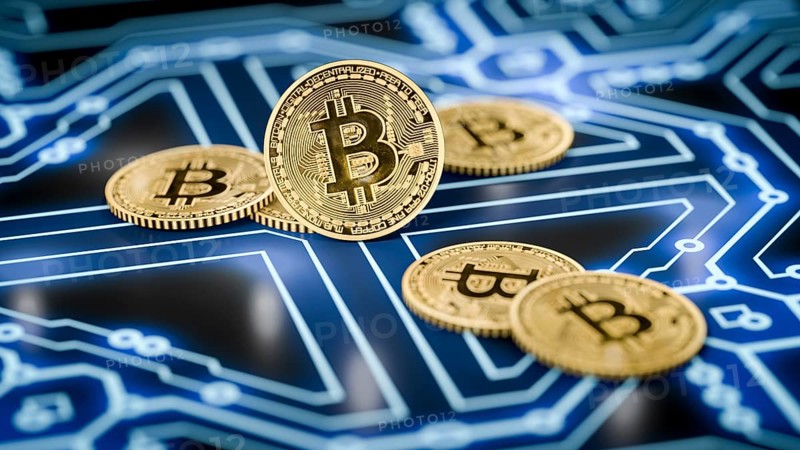3d rendering of a some bitcoin coins on a dark electronic background