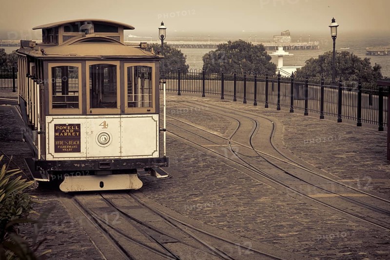 San Francisco cable car at Hyde Street turntable (Fisherman's Wharf) with foggy Aquatic Park in background, sepia toned image