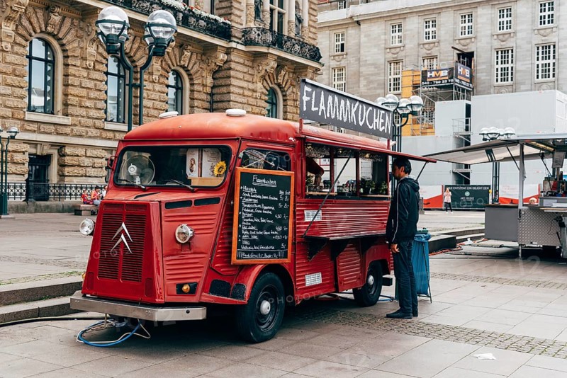 Hamburg, Germany, August 4, 2019: Unidentified man is buying flammkuchen or tarte flambee in a food truck