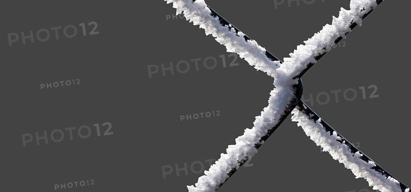 A chain-link fence with hoarfrost