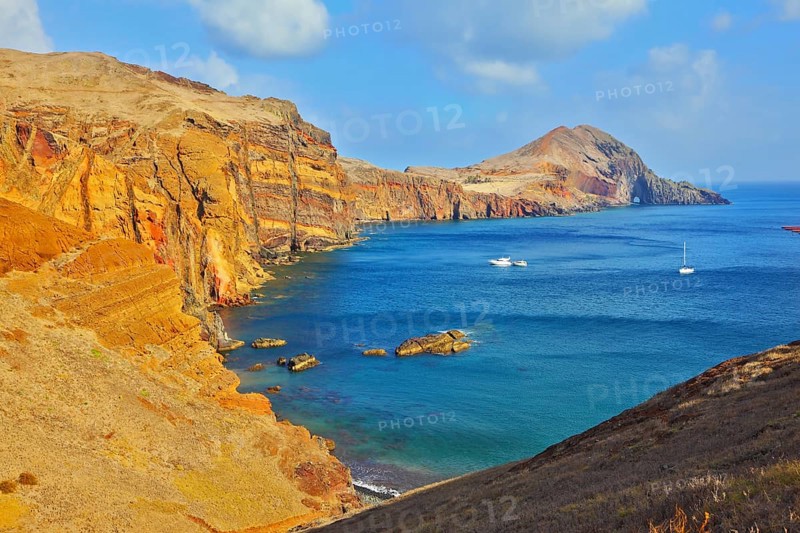 White yachts lit sunset. Quiet ocean cove on the island of Madeira. Calm on the Atlantic Ocean