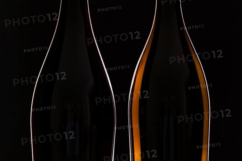 Two different bottles of wine on the black background