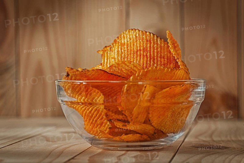 Transparent Glass Bowl Of Potato Chips With Paprika
