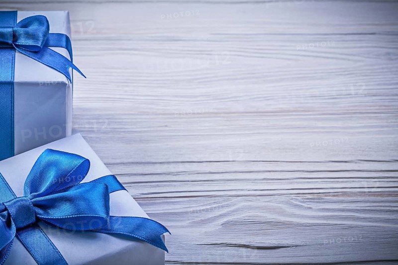 Set of wrapped present boxes on wooden board copy space celebrations concept