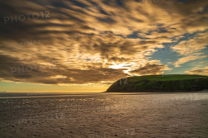 Sunset and dark clouds over the St Bees Heritage Coast near Whitehaven in Cumbria, England, UK