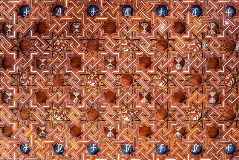 Toledo, Spain, December 6, 2019: Wooden coffered ceiling in the upper level of the cloister of San Juan de los Reyes. Geometric design with moorish influences