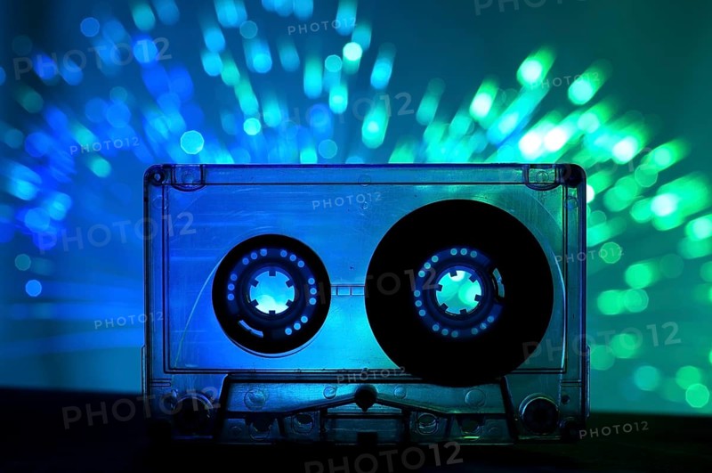 Transparent Cassette tape and blue color disco light background