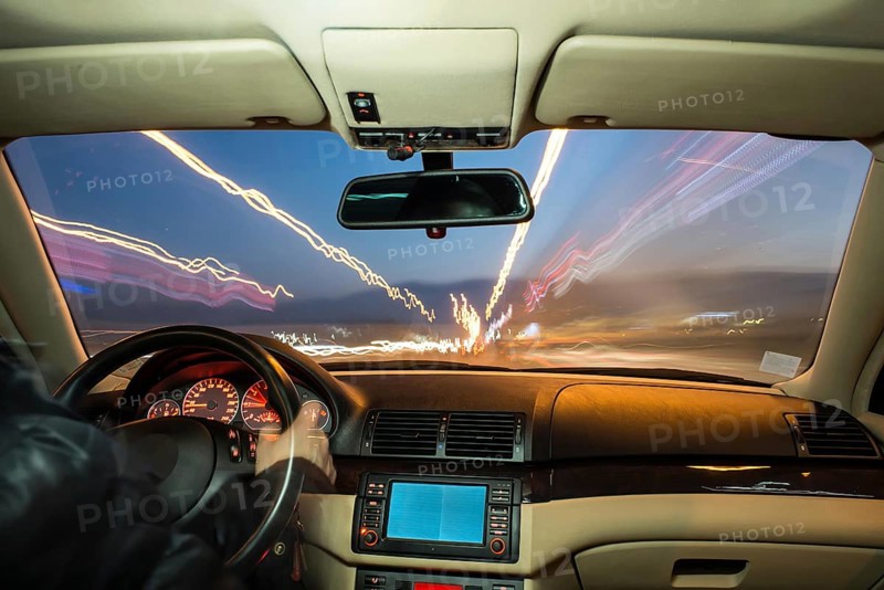 Car interior on driving. Blurred night lights