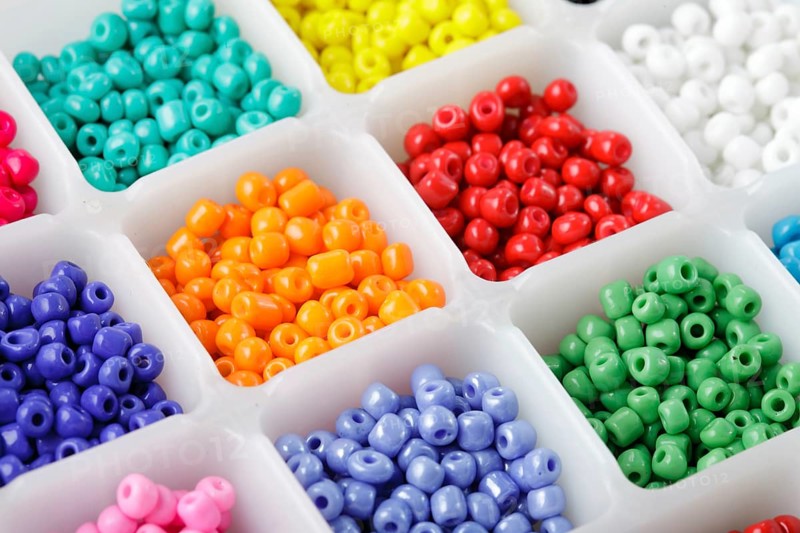 Close up multi colored beads heap in box
