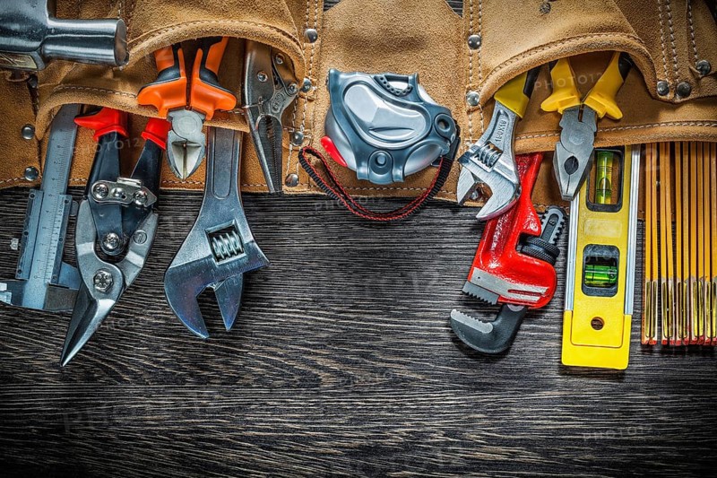 Tool belt with construction tooling on wooden board