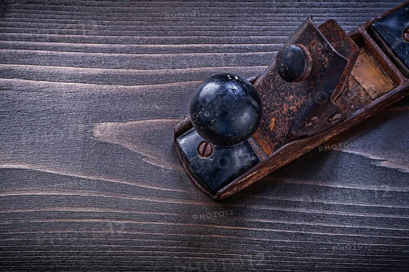Vintage grunge planer on wooden board construction concept