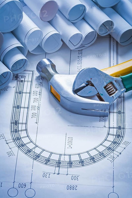 Claw hammer adjustable key and collection of blueprint rolls construction concept
