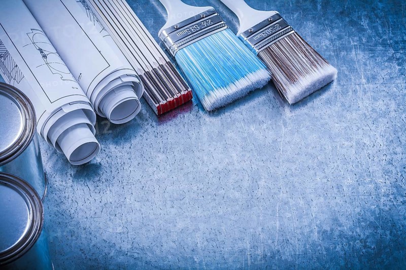 Set of paint brushes cans rolled construction plans wooden meter