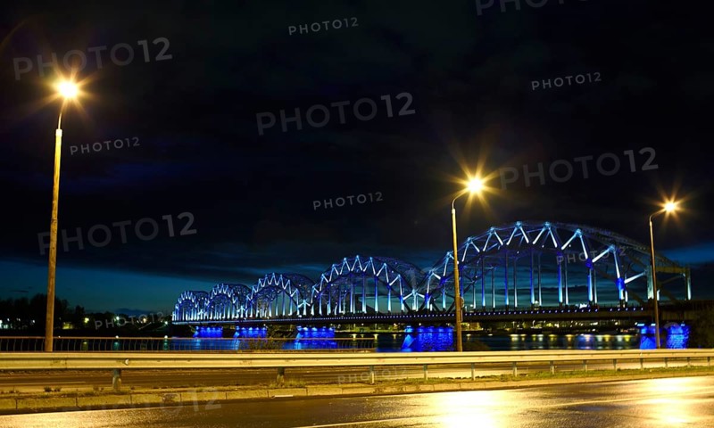 Railway bridge at night with citylights and dark sky