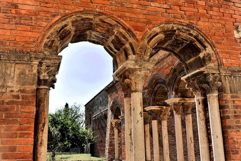 Church ruins of the Cistercian Abbey of San Galgano, Abbazia San Galgano, Gothic, Chiusdino, Tuscany, Italy, Europe, An arched passageway with several stone arches and columns leading into an inner courtyard