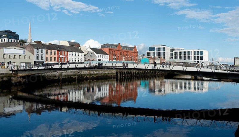 Cork, Ireland, February 24 2023: Mary Elmes pedestrian bridge with people crossing Cork Ireland