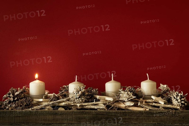 Advent time one candles burning with red background for your content