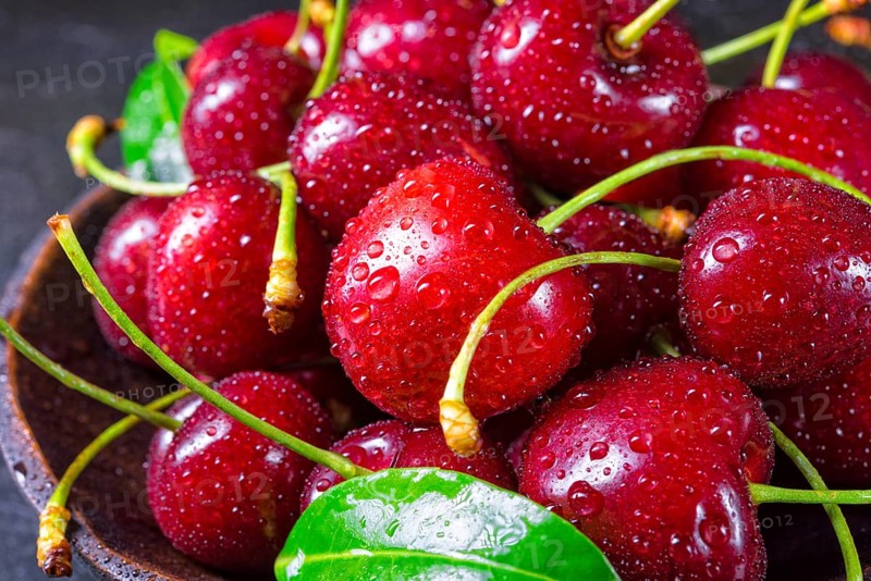 Freshly picked cherry in a wooden bowl