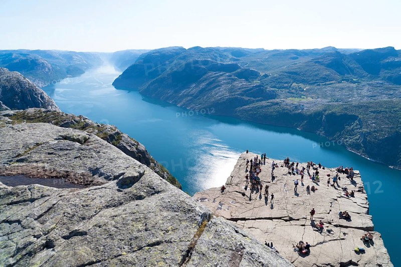PULPIT ROCK, NORWAY, JULY 26, 2018: Unknown tourists enjoying the stunning view on Pulpit Rock. The Pulpit Rock or Preacher?s Chair is a tourist attraction in the municipality of Forsand in Rogaland county