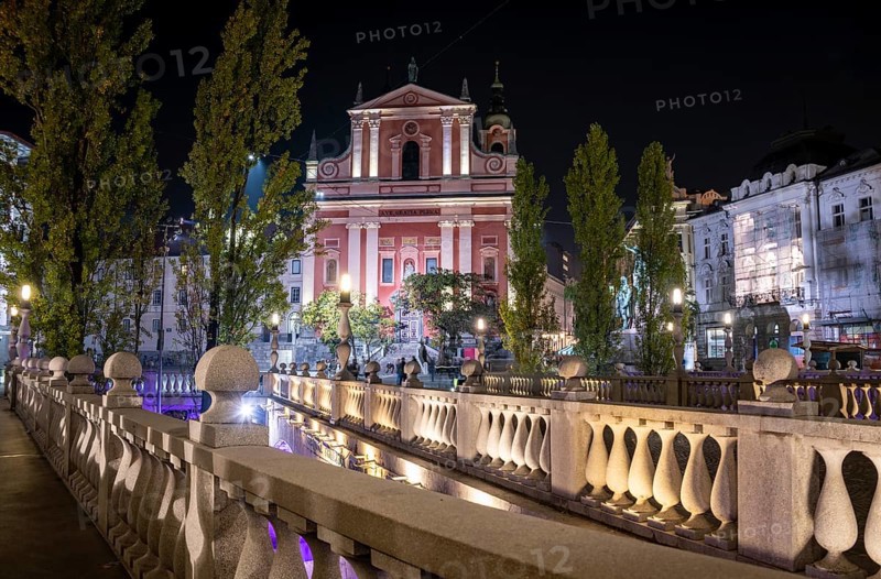 Famous Three Bridges and the Preseren square in the center of Ljubljana illuminated at night, Slovenia