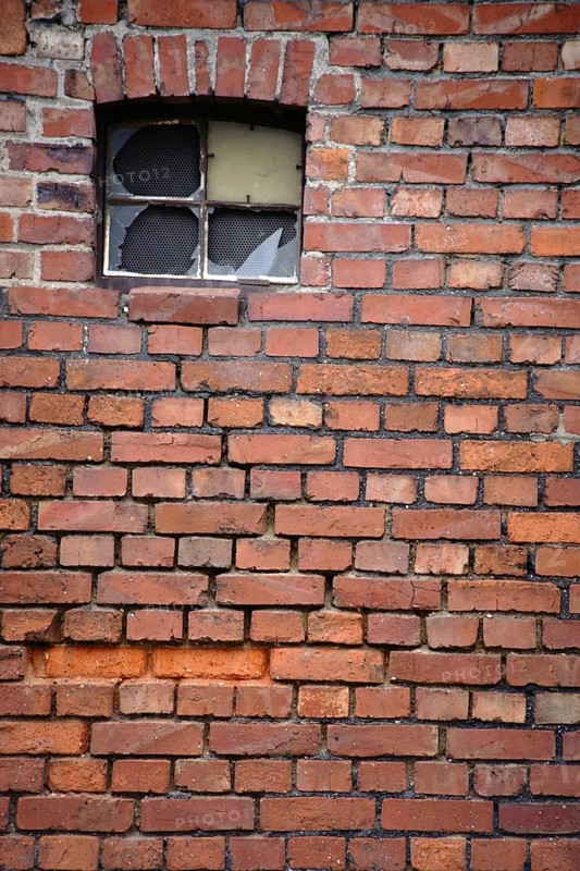 A broken window pane of a disused industrial building