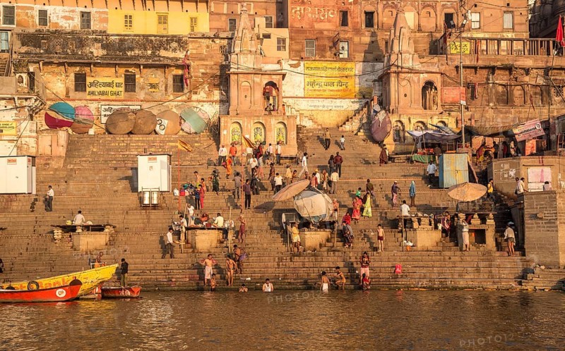Varanasi, India, March 13 2017: India people at the ghats and riverbank of sacred Ganges river for bathing early in the morning