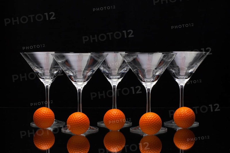 Five glasses of champagne with golf balls