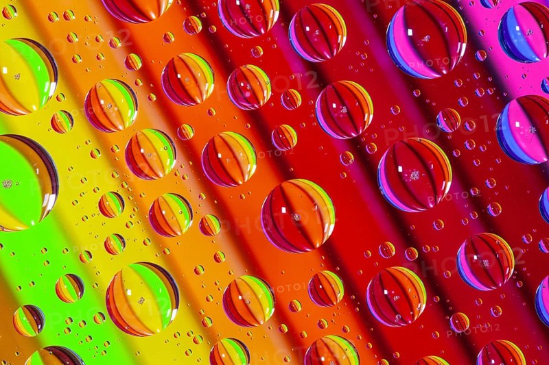 Color pencils under glass with drops of water. Office concept