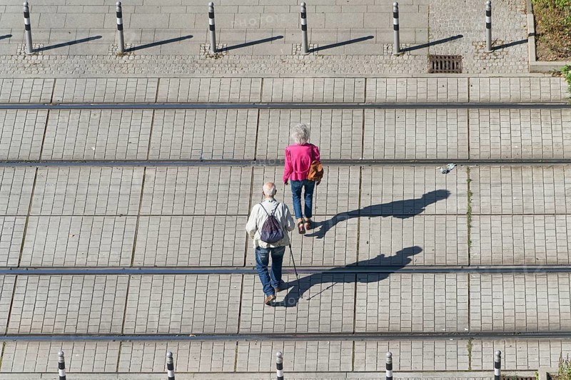Old pensioner couple on their way through the city centre