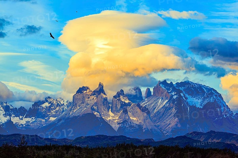 Chile. Torres del Paine National Park. The massive granite towers of Cuernos del Paine. Incredible clouds illuminated by the sunset